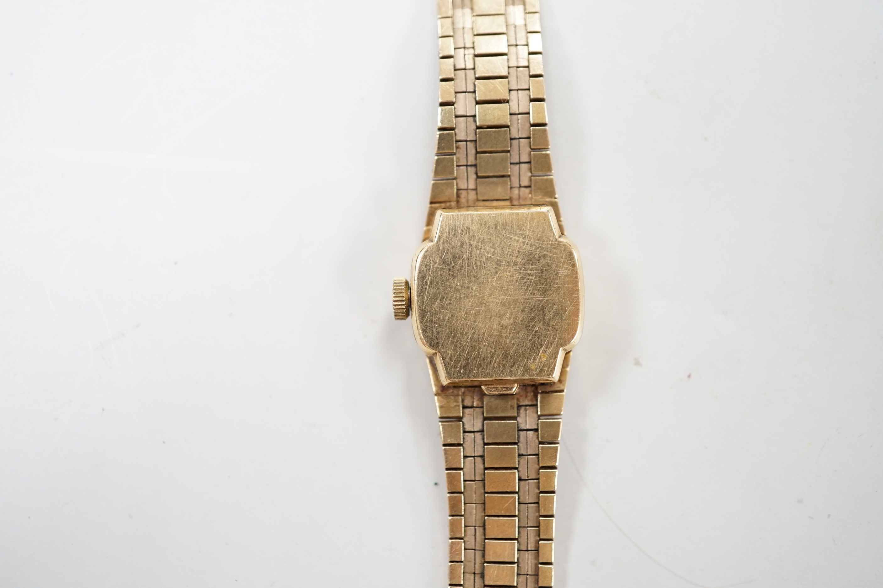 A lady's Omega 9ct gold manual wind wrist watch, with integral 9ct gold bracelet, gross weight 31.3 grams.